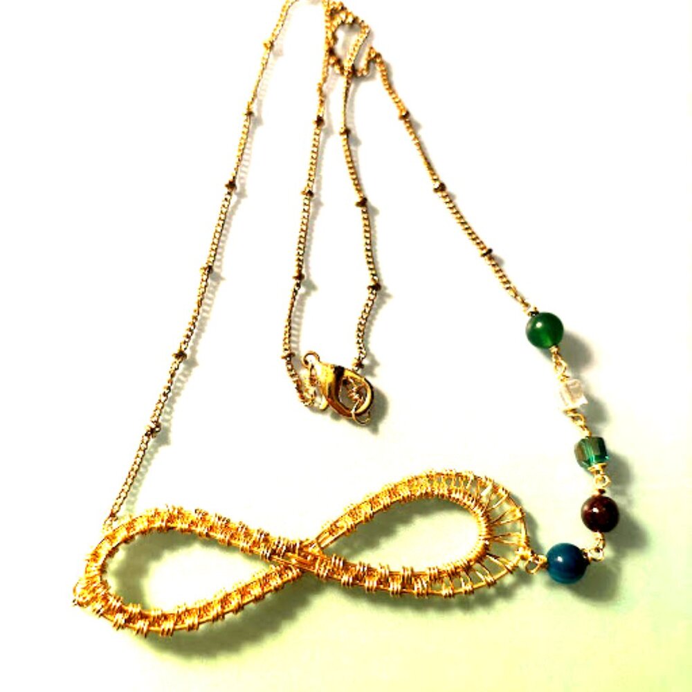 Infinity wrapped pendant on yellow gold plated chain